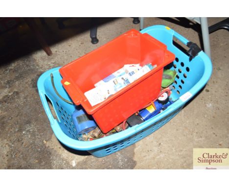 A laundry basket containing a foot pump and tools; and a box containing light bulbs