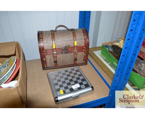 A dome top trinket box together with a traveling chess game