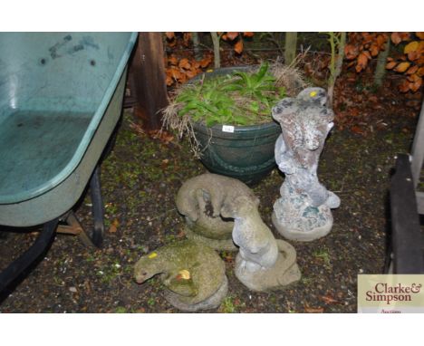Four garden statues and a planter