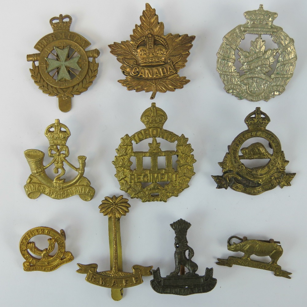 Ten Colonial military badges including; RWAFF (Gaunt London), Bermuda ...