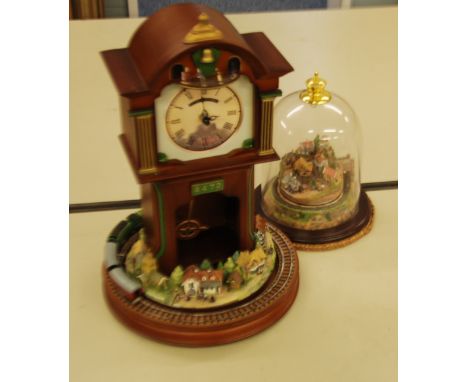 A REPRODUCTION BATTERY CLOCK IN THE FORM OF A LONGCASE CLOCK, WITH ROTATING TRAIN AND VILLAGE SCENE TO BASE 'FLYING SCOTSMAN'
