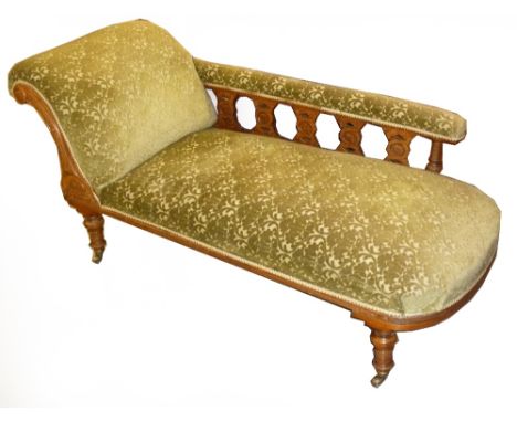LATE VICTORIAN CARVED LIGHT OAK CHAISE LONGUE, WITH SINGLE SCROLL END AND LOW RAISED PADDED BACK WITH FIVE PIERCED SPLAT'S IN