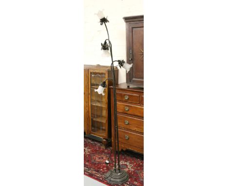 An ornate metal four branch standard lamp.