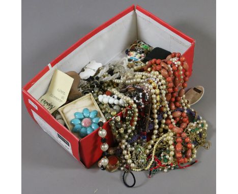 A shoe box full of mixed vintage costume jewellery, mostly beads.