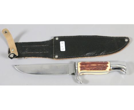 A horn and chrome handled hunting knife with chrome hilt and in leather sheaf.