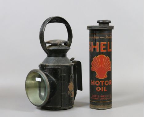 An old railway workers hand lamp along with a vintage Shell oil can.