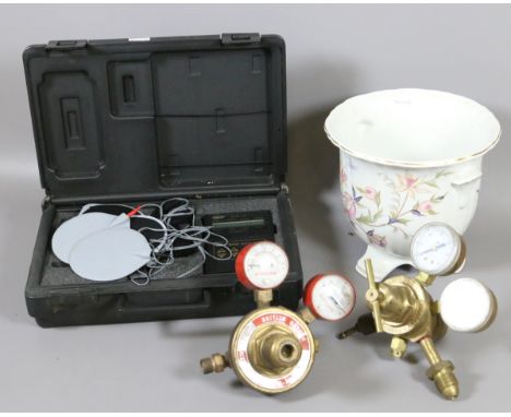 A cased electronic muscle massager along with two oxygen and acetylene regulators and a Royal Winton planter.