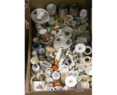 A box of ceramic ornaments and teawares to include Wade Whimsies, Royal Crown Derby coffee cup and saucer, silver topped vase