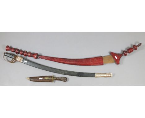Two Indian tourist ware swords along with a dagger.