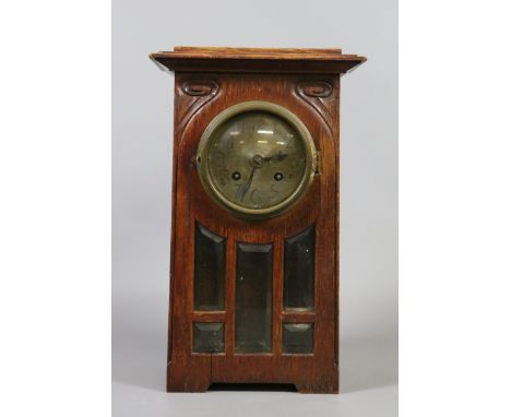 An oak cased arts and crafts mantel clock in the Manner of Archibald Knox.