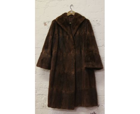 A ladies full length fur coat.