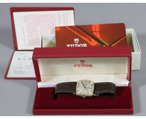 A 9ct gold cased vintage Tudor manual wristwatch on leather strap with original box and papers with square satin dial having 