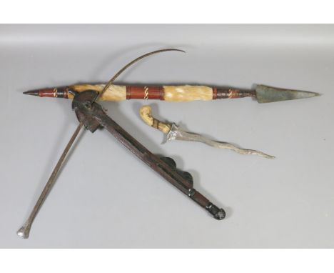An African Mangbetu style figural hand axe a Malayan Kris and an African souvenir spear.