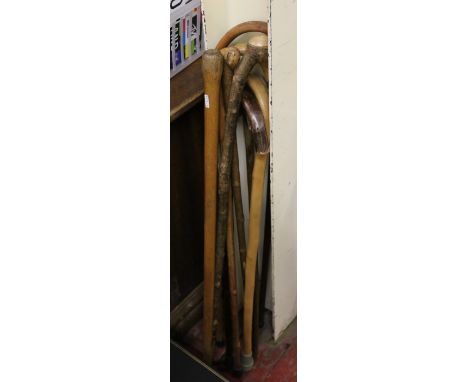 A collection of walking sticks to include a deputy's yard stick.