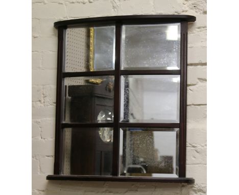 A mahogany six pane bevelled wall mirror with shelf.