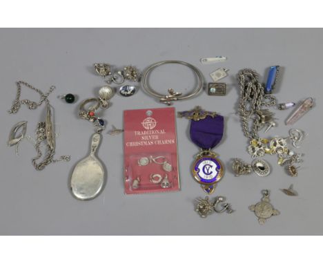 A box of assorted silver collectables including enamel gilt Manchester Unity medal, traditional silver Christmas charms and j