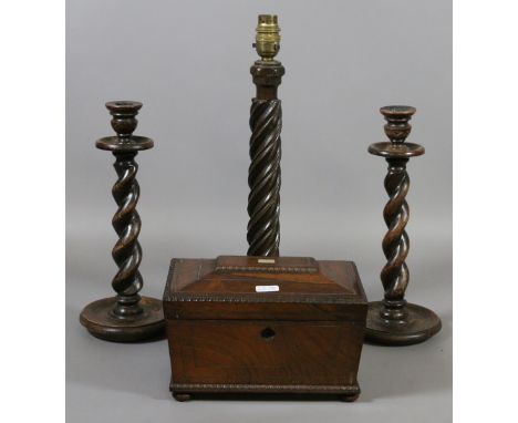 A Regency rosewood tea caddy, pair of oak barleytwist candlesticks and an oak twist carved tablelamp base.