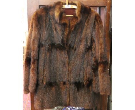 A ladies half length fur coat.