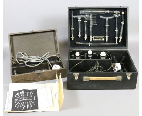 A boxed Ajar violet ray electric shock wand along with another boxed vintage violet ray machine and apparatus.
