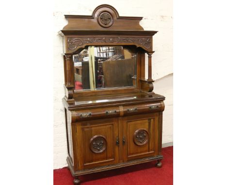 A Victorian mahogany mirrorback sideboard with roll fronted drawers, Art Nouveau handles and relief roundels to the doors. Ra