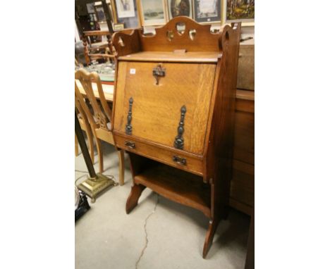 Arts and Crafts Oak Students Bureau, the back rail carved with hearts, the hinged drop front with Art Nouveau Fittings with d