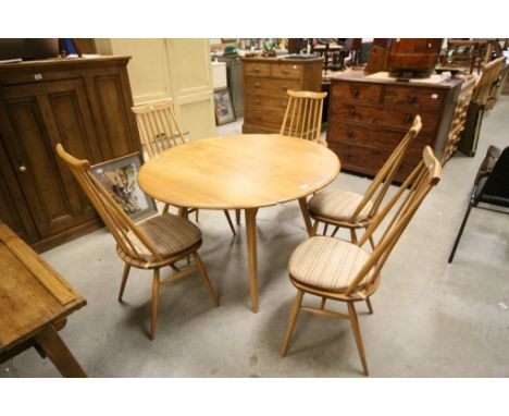 Ercol Pale Elm Drop Flap Circular Dining Table raised on four square tapering legs together with Five Ercol Stickback Dining 