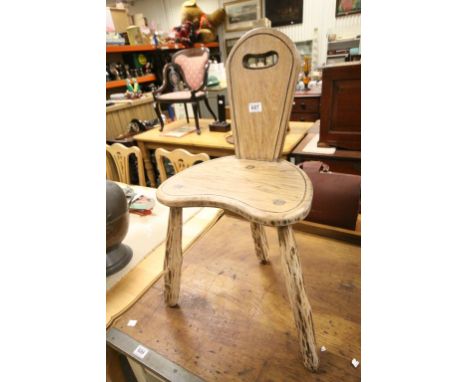 Rustic Elm Milking Chair raised on three stick legs