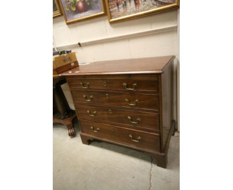 Early 19th century Mahogany Chest of Four Long Drawers with Brush Slide and raised on bracket feet