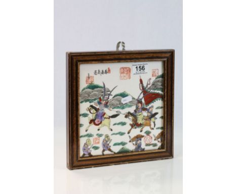 Wooden framed Oriental ceramic Tile depicting Warriors fighting