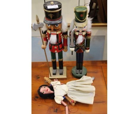 A pair of novelty wooden toy soldiers, together with a puppet