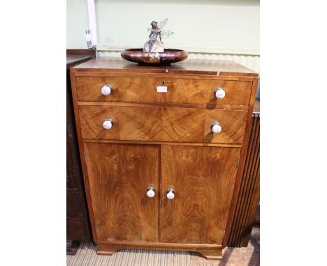 A walnut veneer tallboy with ceramic pink rose handles.