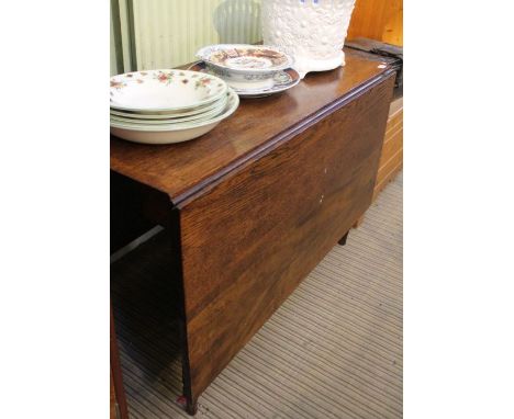 A 19th century oak twin flap dining table on ring turned legs.