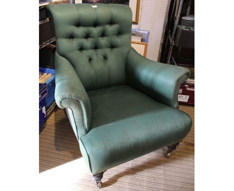A Victorian green damask upholstered deep seated armchair with button back.