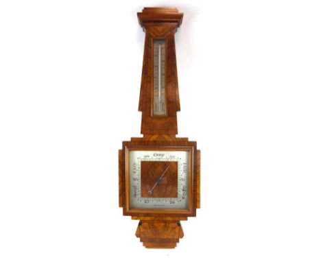 A 1930's walnut crossbanded barometer and thermometer of Art Deco design, h. 82 cm CONDITION REPORT: Glass cracked, working o