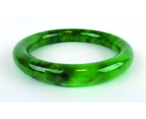 A green jade bangle, internal d. 5.9 cm
