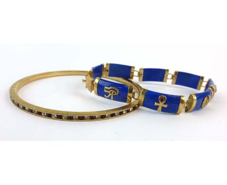 A 9ct yellow gold bracelet set eight sections of lapis lazuli each depicting an Egyptian symbol, together with a gold coloure