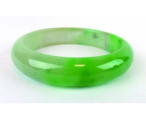 A green/white jade bangle, internal d. 6.2 cm