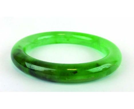 A green jade bangle, internal d. 5.9 cm