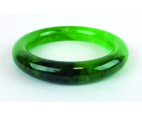 A green jade bangle, internal d. 5.6 cm