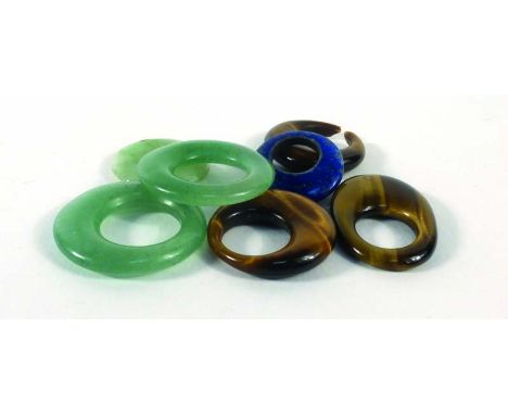 Three pale green jade pendants, three similar tiger's eye pendants and a lapis lazuli example (7) CONDITION REPORT: Some dama
