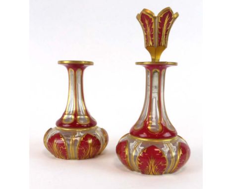 A 19th century Bohemian decanter and stopper of squat form, h. 17 cm, together with a matching decanter (2) (af)   CONDITION 