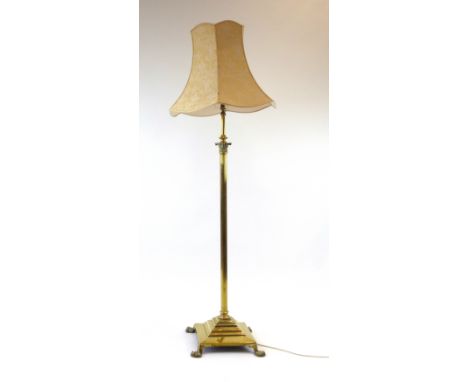 A Victorian brass telescopic standard lamp on a Neo-Classical column with a platform base and claw feet CONDITION REPORT: Wor