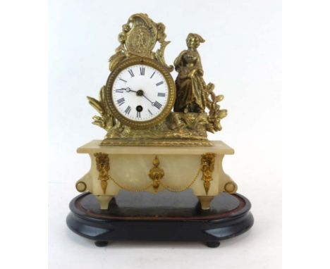 A late 19th century mantle clock, the enamelled face with Roman numerals, within an alabaster and gilt metal figural case, on