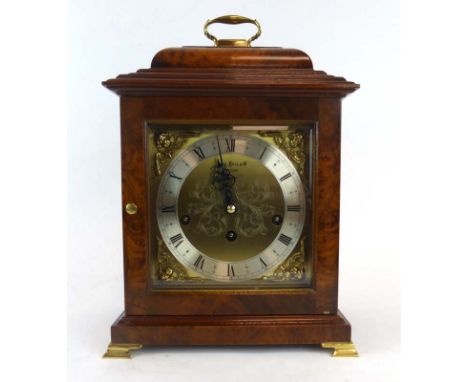 Keninger for Comitti of London, a mantle clock, the brass face with Roman numerals, the movement striking on a gong, within a