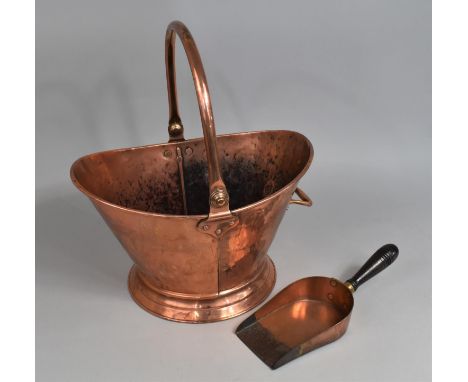A 20th Century Hand Beaten Copper Helmet Shaped Coal Scuttle and a Wooden Handled Scoop 