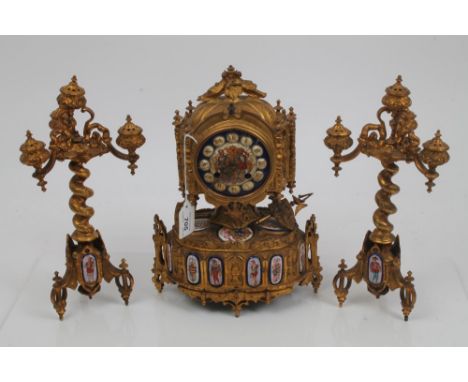 Mid-19th century French ormolu and porcelain mounted clock garniture in the 16th century gothic taste, the clock in architect