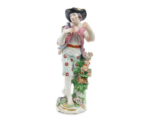 18th century Chelsea figure of a traveller with a barrel on a stick over his back, on floral encrusted base - gold anchor mar