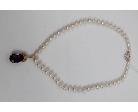 Cultured pearl necklace with a string of cultured pearls measuring approximately 7.5mm - 8mm diameter, with a pear cut amethy