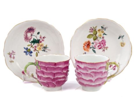 Pair 18th century Meissen porcelain coffee cups and saucers with puce petal moulding and green stalk and leaf handles, polych
