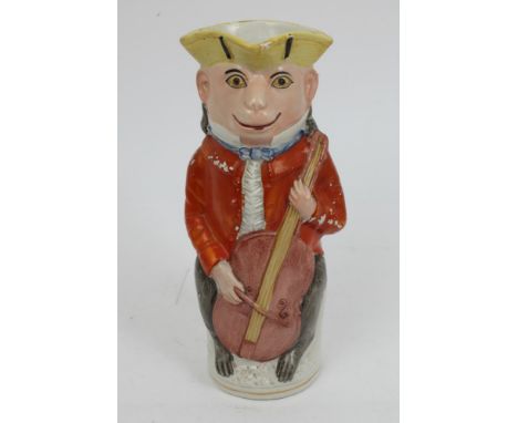 Victorian Staffordshire Toby jug modelled as a monkey playing a cello, 30cm high